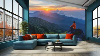 A man who hikers enjoy a break look at the top of the mountain at sunset adventure travel. Wall mural