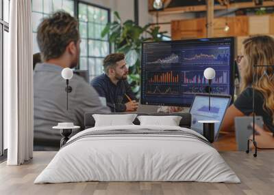 Businessmen sit in a meeting and analyze profits with graphs displayed on a screen in the office. Wall mural