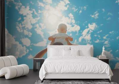 Father carrying his cheerful son on his shoulders with the bright sky. Wall mural