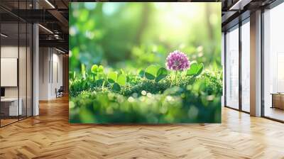 A captivating close-up of a blooming clover flower, showcasing intricate petals and vibrant colors, framed beautifully by a backdrop of lush green foliage in a serene meadow setting. Wall mural