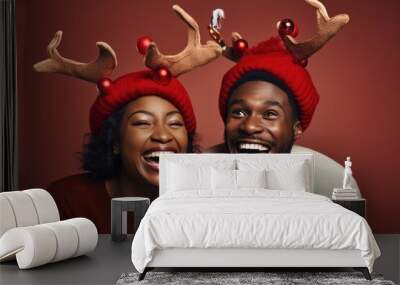 A couple wearing reindeer antlers on their heads, spreading holiday cheer Wall mural