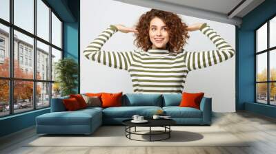 A woman with curly hair wearing a striped shirt Wall mural