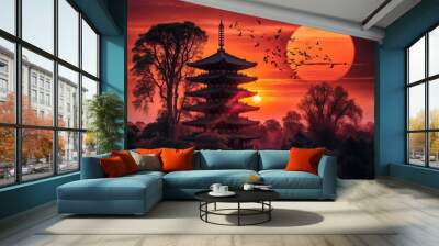 Silhouette of a traditional multi-tiered pagoda surrounded by trees at sunset, with a large, vibrant, orange-red sun and a flock of birds flying across the sky. Use for wallpaper Wall mural