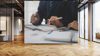 Financial analysts analyze business financial reports on a digital tablet planning investment project during a discussion at a meeting of corporate showing the results of their successful teamwork. Wall mural