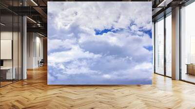 Blue sky background with white clouds and rain clouds. The vast blue sky and clouds sky on sunny day. White fluffy clouds in the blue sky. Wall mural