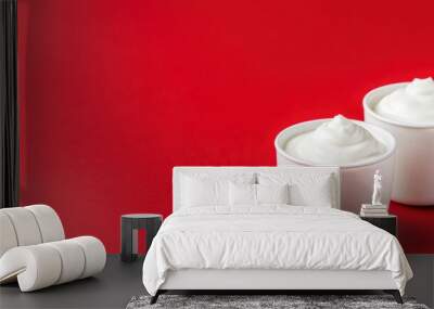 Two Bowls of Sour Cream on Red Background. Wall mural