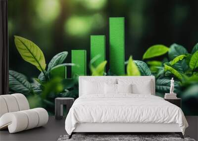 A close-up of a rising green bar graph surrounded by fresh leaves, symbolizing the idea of economic growth rooted in environmental sustainability. Wall mural