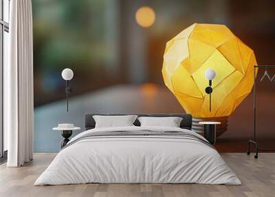 A close-up of a yellow paper ball with a virtual light bulb graphic, symbolizing inspiration and the generation of new ideas. Wall mural