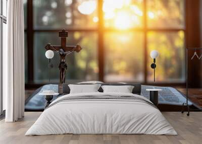 A silver crucifix resting on an open prayer book with sunlight streaming through a window. Focus on the crucifix and text. No people. Wall mural