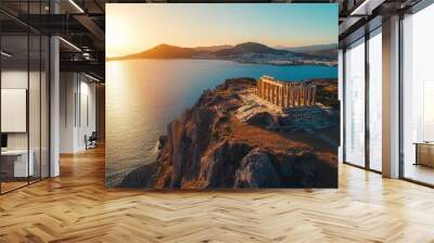 Aerial view of Sounio's Temple of Poseidon, overlooking the shimmering Aegean Sea at golden hour Wall mural