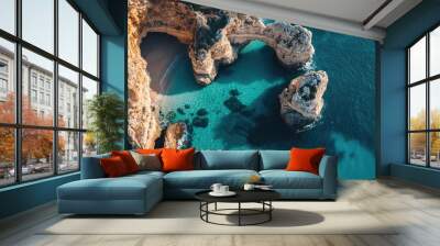 Aerial view of the dramatic cliffs and turquoise waters of Praia da Marinha in Algarve, with rock formations and caves Wall mural