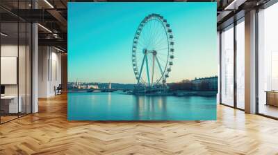 Ferris wheel standing tall against a clear blue sky, with scenic views in the background. No people. Wall mural