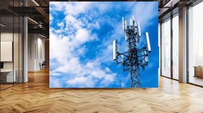 A high-speed 5G cell tower against a blue sky, symbolizing fast and reliable mobile network technology. Wall mural