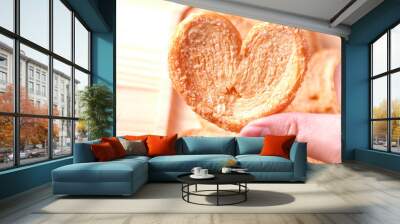 Pie a butterfly, heart shaped patty crispy with sugar in hand Wall mural