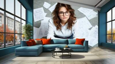 Young Entrepreneur Sitting on Floor with Papers and Blueprints for Startup in Modern Apartment Wall mural