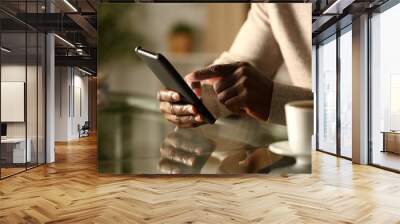 Black man hands checking smart phone at night Wall mural