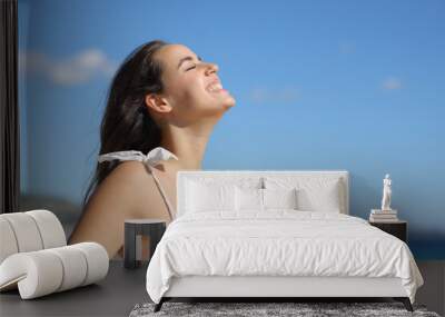 Happy woman breathing and laughing on the beach Wall mural