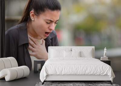 Stressed woman having problems to breath in a park Wall mural