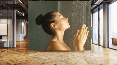 Woman showering rubbing hands under water jet Wall mural