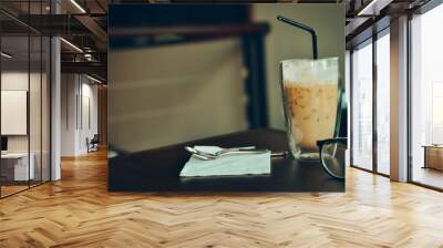 Iced coffee latte on the wooden table. Wall mural