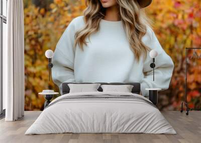 Portrait of a young woman wearing a crewneck white mockup sweatshirt with fall colors and themed background for autumn season female fashion Wall mural