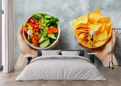 Unhealthy vs healthy food. vegetable salad and potato in different hands on green background . Choice between fast foods and vegetables, fruit. Wall mural