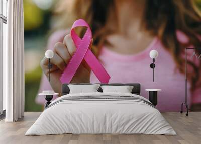 woman holding pink ribbon breast cancer awareness. concept healthcare. Wall mural