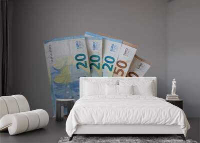 A man has several euro banknotes in his hand and signals that he wants to pay. Wall mural