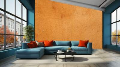 A rough burned orange ochre colored textured stained wall background Wall mural