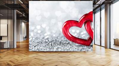 Banner Of Two Red Wooden Interlocking Hearts On Silver Glitter With Heart Shaped Bokeh Background - Valentine's Day / Marriage Concept Wall mural