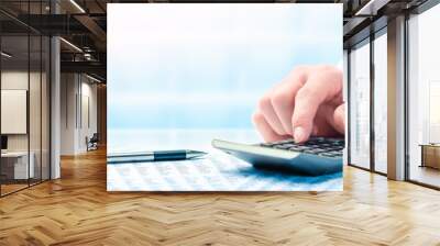 Business Man Using Calculator On Desk With Pen, Reading Glasses, And Financial Report- Business Accounting Concept	 Wall mural