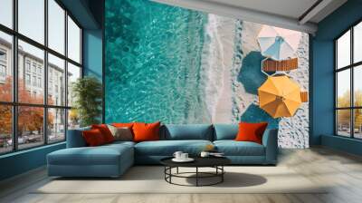 Yellow beach umbrella on sandy coast near sea, top view Wall mural