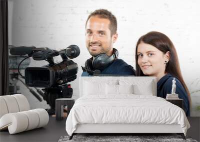 a young man and a young woman with a movie camera Wall mural