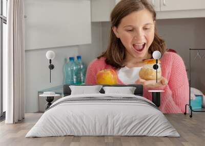 teenage girl chosen with sweet pastry and organic apple Wall mural