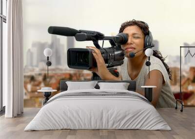 young African American women with professional video camera Wall mural