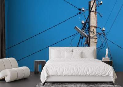 Concrete pole with lantern and lots of electric wires Wall mural