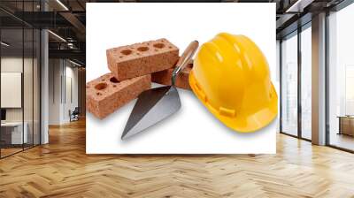 A set of house building bricks and trowel, with a yellow hard hat, isolated on a white background Wall mural