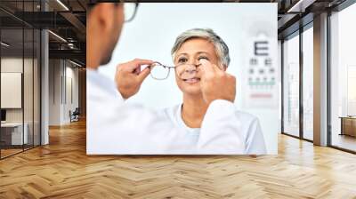 Consulting, optometry and medical with old woman and doctor for eye care, glasses and lens. Healthcare, ophthalmology and vision with senior patient in clinic for exam, eyesight and prescription Wall mural