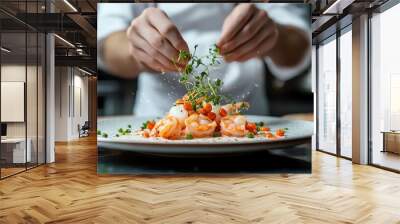 A chef elegantly garnishes a gourmet shrimp dish with fresh herbs, showcasing culinary skill and creativity in a beautiful kitchen setting. Wall mural