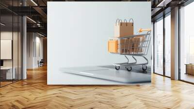 A shopping cart with a paper bag on a laptop, depicting online shopping and e-commerce in a modern digital environment. Wall mural