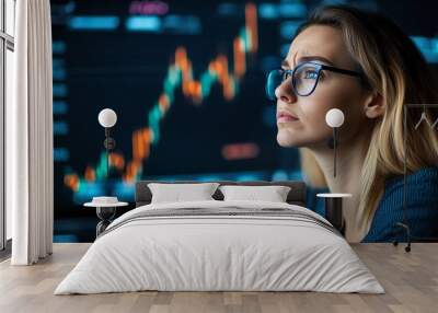 Focused woman analyzing stock market trends with digital charts in background. Ideal for finance and investment concepts. Wall mural