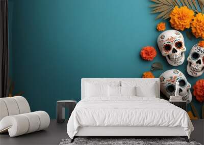 Vibrant decoration with colorful skulls, marigold flowers, and tropical leaves on a teal background for festive celebrations. Wall mural