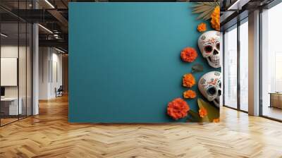 Vibrant decoration with colorful skulls, marigold flowers, and tropical leaves on a teal background for festive celebrations. Wall mural