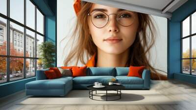 A young woman in a hard hat and glasses looks confidently at the camera, holding a blueprint. Wall mural