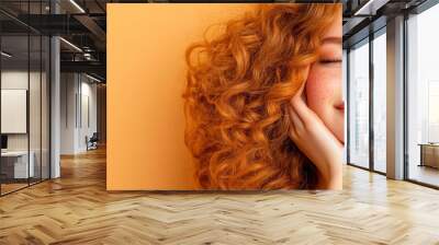 Teenage girl with acne on her temples, smiling softly against a beige background Wall mural