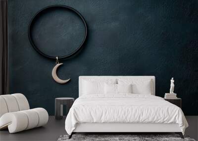 A thin choker with a minimalist moon charm, black and silver, high contrast, dark background Wall mural