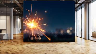 Burning sparkler with blurred bokeh cities light background Wall mural