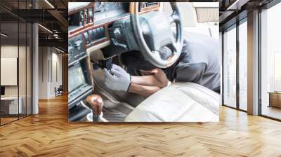 Automotive electrician  mechanic or technician fixing or repairing car interior wire system. Car service concept. Wall mural