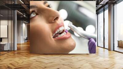 Closeup , teeth polishing procedure , closeup of beautiful young woman face  Wall mural