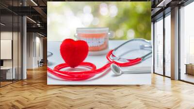 Red heart and health care equipment, teeth and mouth on the background green blurred. Wall mural